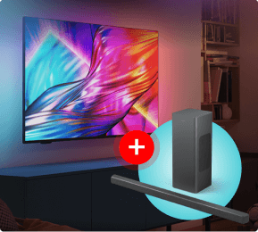 Kolorowy ekran telewizora z dynamicznymi, abstrakcyjnymi wzorami w odcieniach niebieskiego, fioletowego, różowego i pomarańczowego. Przed telewizorem widoczny jest zestaw głośników z symbolem plusa na czerwonym tle, co sugeruje promocję lub zestawienie produktów.